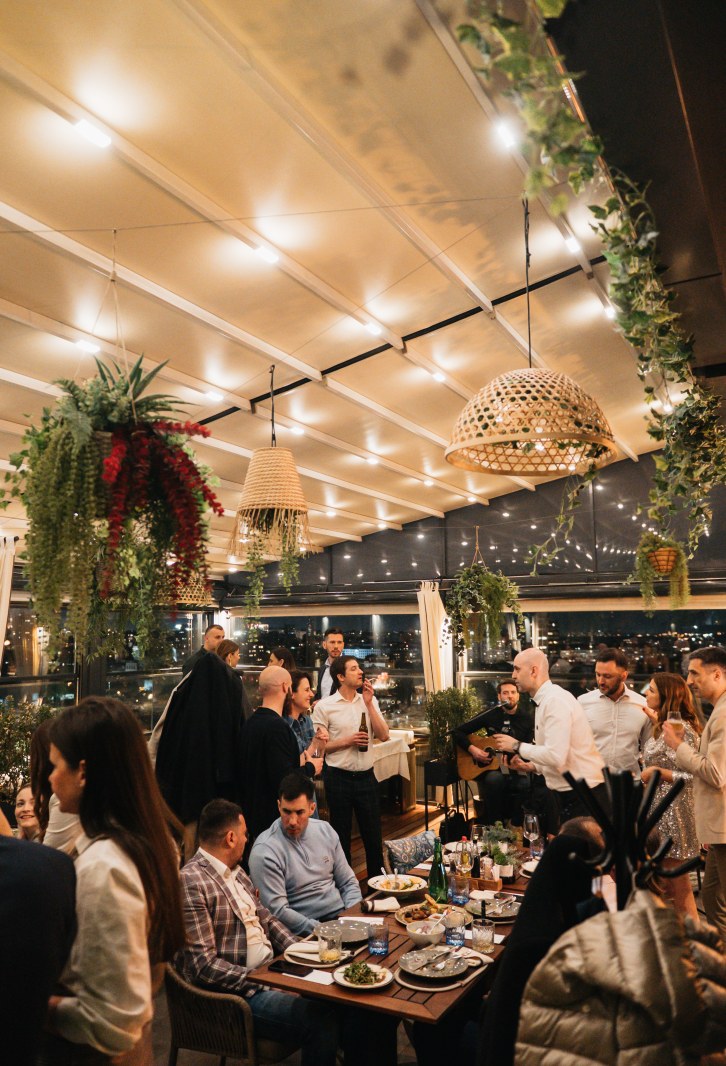 Guests and live music at Heritage Rooftop restaurant