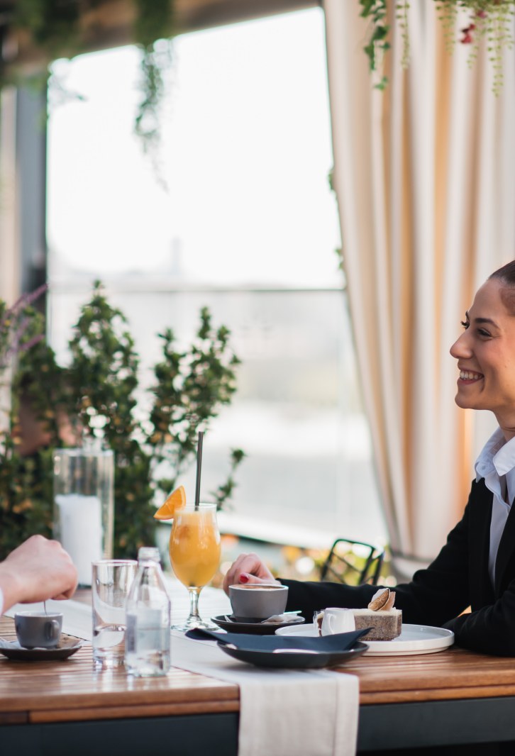 A guest and team member at Heritage Rooftop restaurant